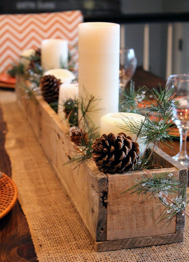 Succulents, rocks, pine cones, flowers in wood boxes for centerpieces